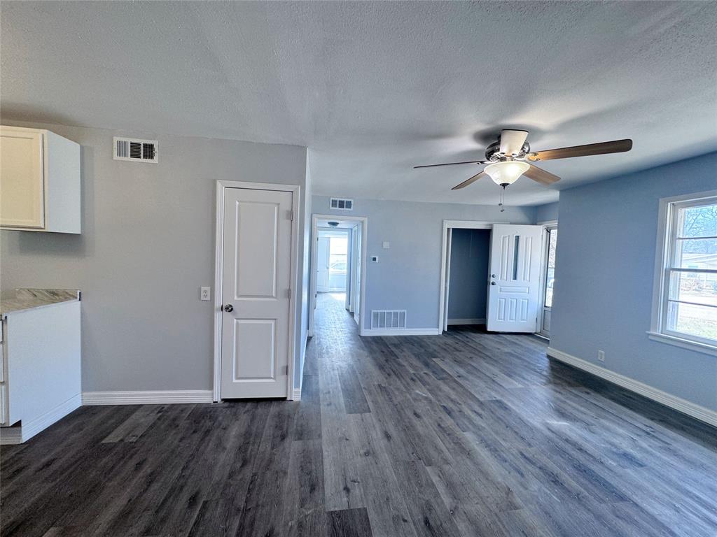 345 16th Street Southwest Paris, TX 75460 - Photo 3 of 15 a view of a livingroom with wooden floor and a ceiling fan