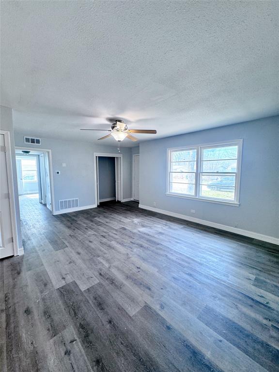 345 16th Street Southwest Paris, TX 75460 - Photo 5 of 15 an empty room with wooden floor and windows