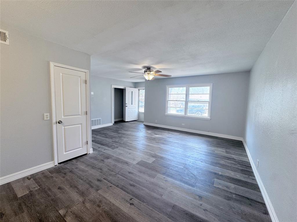 345 16th Street Southwest Paris, TX 75460 - Photo 6 of 15 wooden floor in an empty room with a window