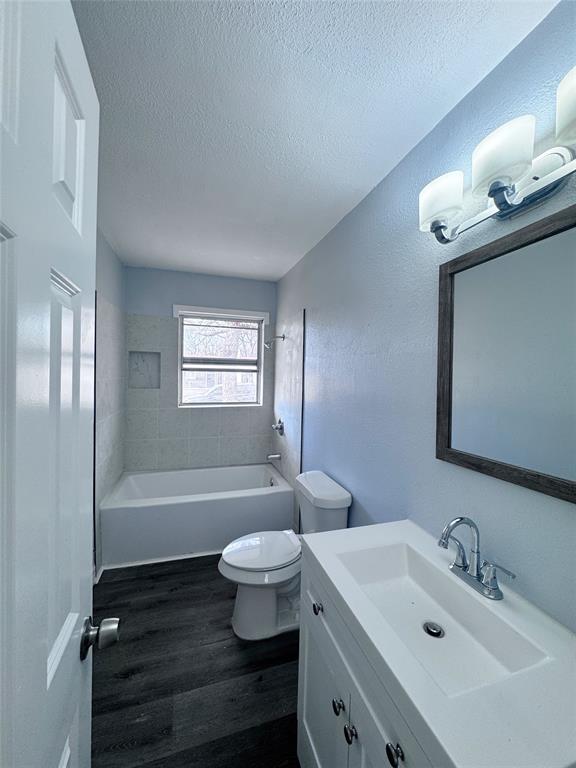 345 16th Street Southwest Paris, TX 75460 - Photo 7 of 15 a bathroom with a sink a toilet and bathtub