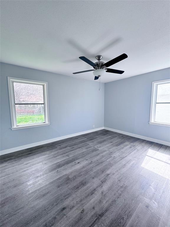 345 16th Street Southwest Paris, TX 75460 - Photo 9 of 15 a view of an empty room with wooden floor and a window