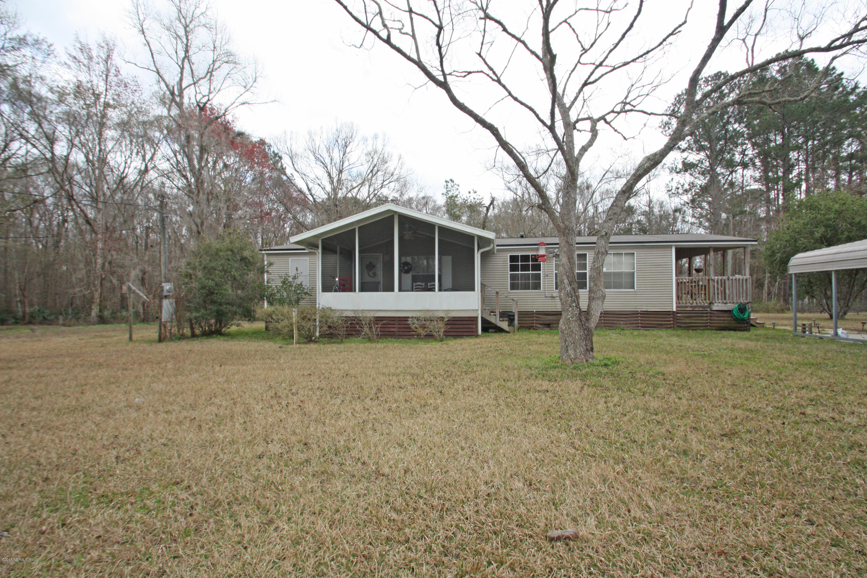 54170 Vontz Road East Callahan, FL 32011 - Photo 1 of 24 a house with trees in front of it