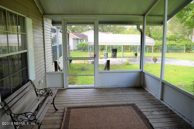54170 Vontz Road East Callahan, FL 32011 - Photo 15 of 24 a view of an empty room with wooden floor and windows