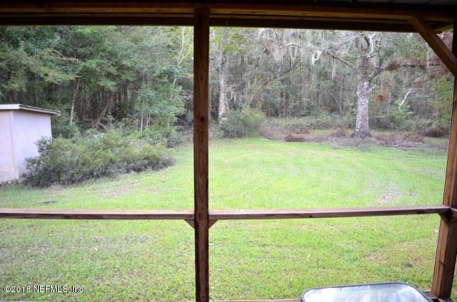 54170 Vontz Road East Callahan, FL 32011 - Photo 17 of 24 a view of large green trees from a window