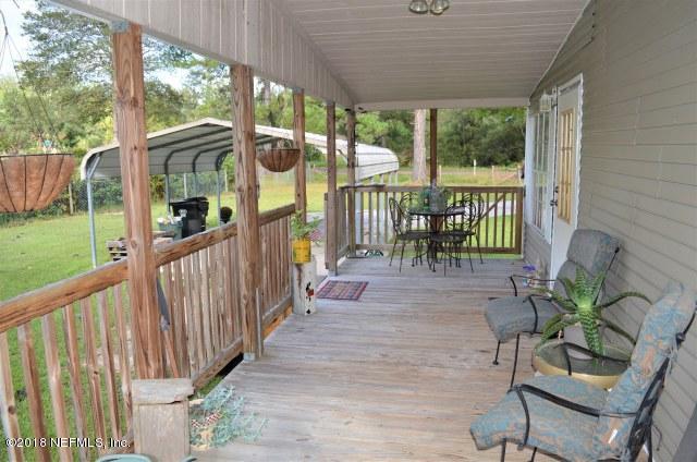 54170 Vontz Road East Callahan, FL 32011 - Photo 19 of 24 a view of a porch with chairs and backyard