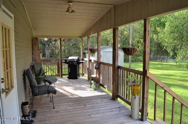 54170 Vontz Road East Callahan, FL 32011 - Photo 20 of 24 a view of a porch with wooden floor and outdoor space