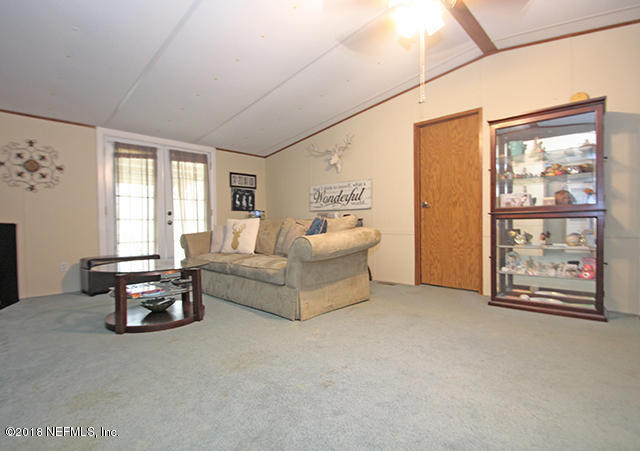 54170 Vontz Road East Callahan, FL 32011 - Photo 6 of 24 a living room with furniture and a large window