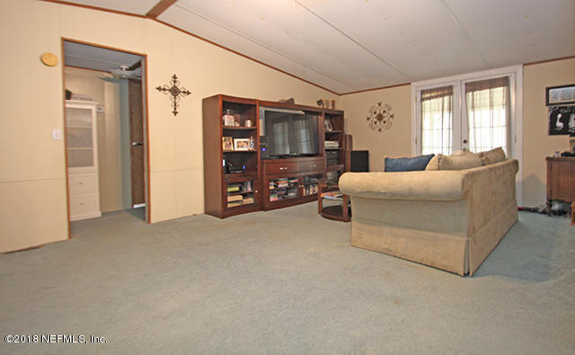 54170 Vontz Road East Callahan, FL 32011 - Photo 7 of 24 a living room with furniture and a flat screen tv