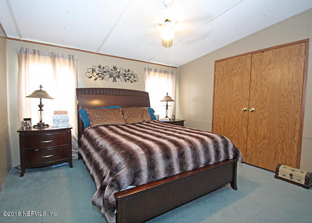 54170 Vontz Road East Callahan, FL 32011 - Photo 8 of 24 a bedroom with a bed and a closet
