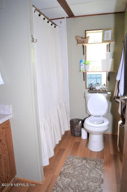 54170 Vontz Road East Callahan, FL 32011 - Photo 9 of 24 a bathroom with a toilet and a shower