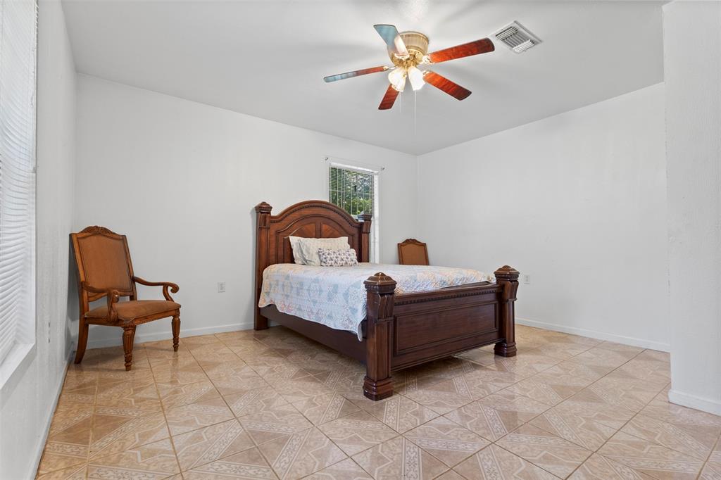 2821 Burchill Road South Fort Worth, TX 76105 - Photo 13 of 33 Bedroom featuring a ceiling fan and light tile patterned flooring