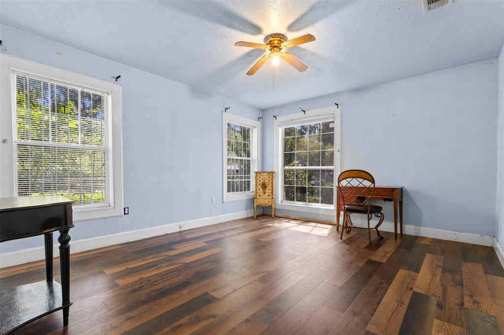 2821 Burchill Road South Fort Worth, TX 76105 - Photo 15 of 33 Living area featuring dark wood-style floors, a textured ceiling, and ceiling fan