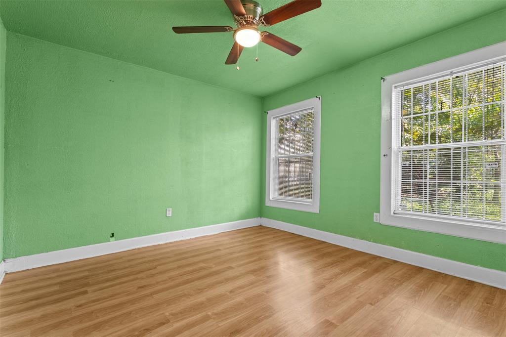 2821 Burchill Road South Fort Worth, TX 76105 - Photo 17 of 33 Empty room featuring wood finished floors and a ceiling fan