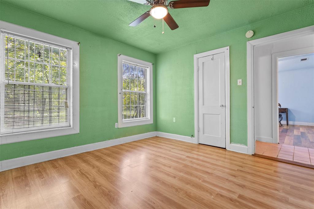 2821 Burchill Road South Fort Worth, TX 76105 - Photo 18 of 33 Unfurnished bedroom with wood finished floors, a ceiling fan, and a textured ceiling