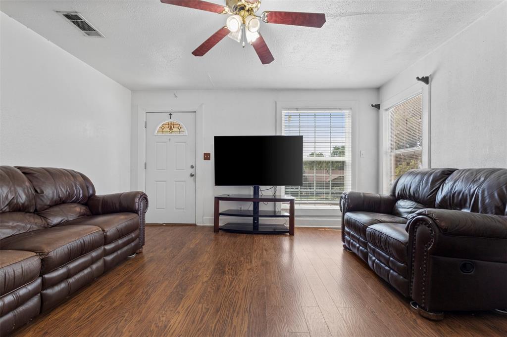 2821 Burchill Road South Fort Worth, TX 76105 - Photo 6 of 33 Living room featuring wood finished floors, a textured ceiling, and ceiling fan