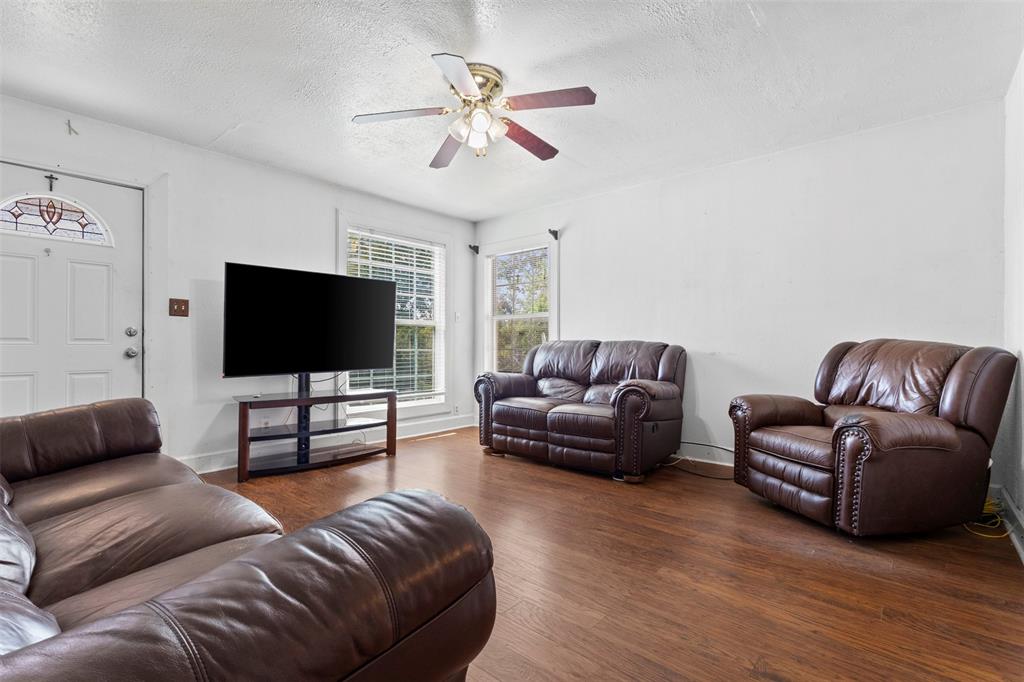 2821 Burchill Road South Fort Worth, TX 76105 - Photo 7 of 33 Living area featuring a textured ceiling, wood finished floors, and a ceiling fan