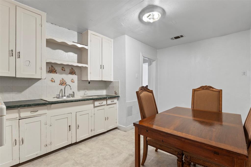 2821 Burchill Road South Fort Worth, TX 76105 - Photo 9 of 33 Kitchen with decorative backsplash, white cabinets, open shelves, and light flooring
