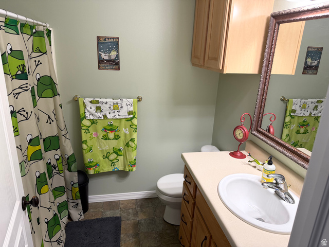 202 375 West Providence, UT 84332 - Photo 23 of 61 Full bath with vanity, a shower with curtain, and stone finish flooring
