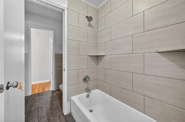 a bathroom with a bathtub and shower