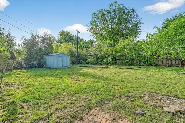 a view of a backyard with large trees