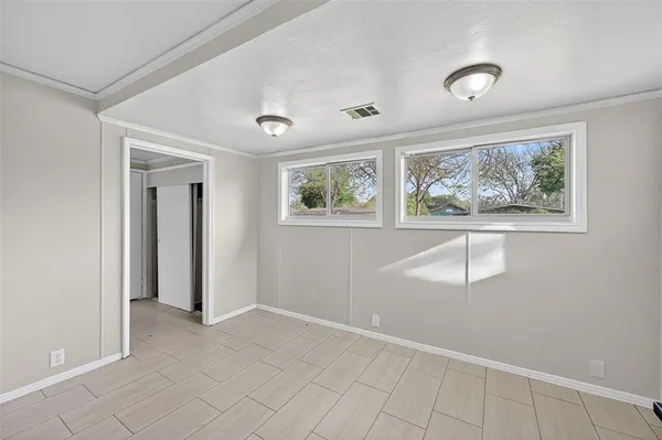 an empty room with windows and closet