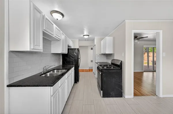 a kitchen with a stove a refrigerator and a sink