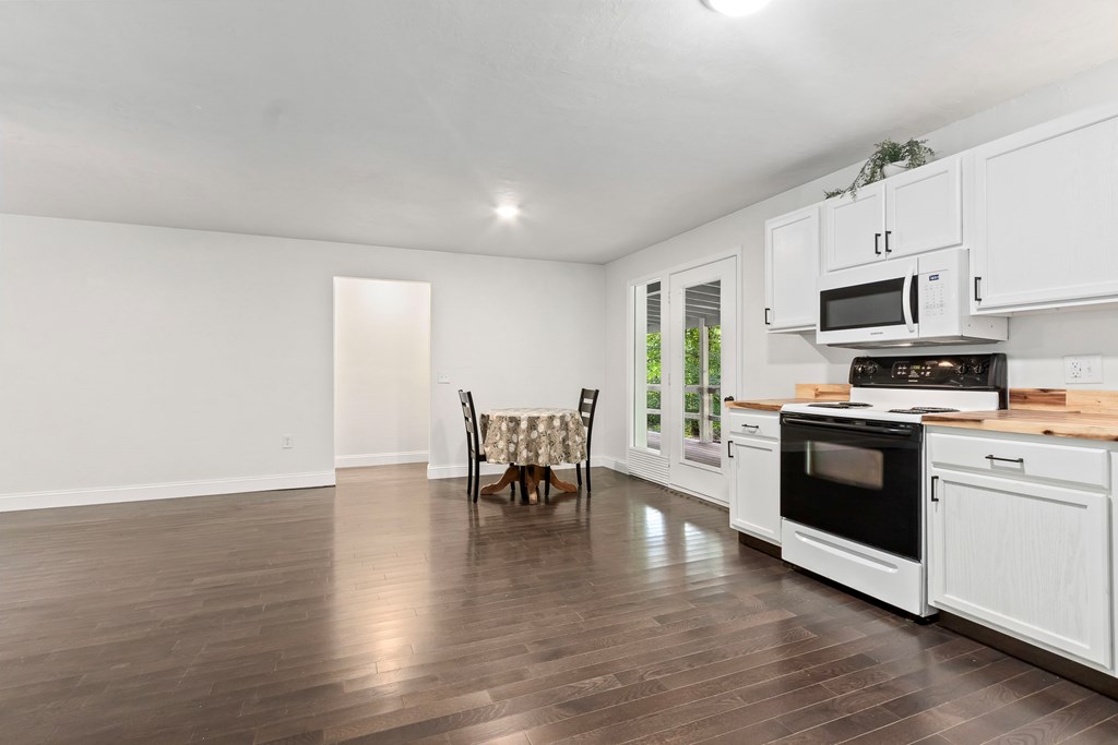 123 Quarry Road Andrews, NC 28901 - Photo 14 of 51 a kitchen with stainless steel appliances a stove top oven a sink dishwasher and a refrigerator with wooden floor