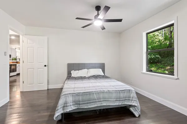 a bedroom with a bed and a chandelier