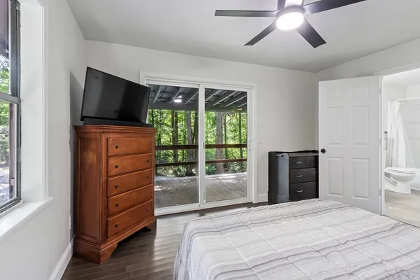 a bedroom with a bed and a television