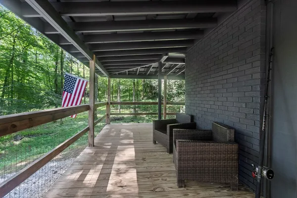 a view of two chairs in the deck next to a yard
