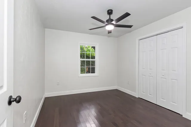 wooden floor in an empty room with a window