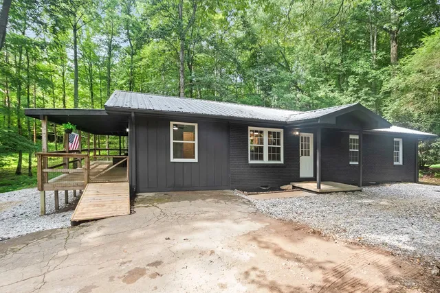 a front view of a house with a garden