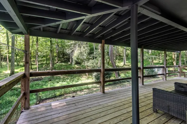 a view of trees and deck in the house