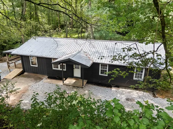 a house with trees in the background