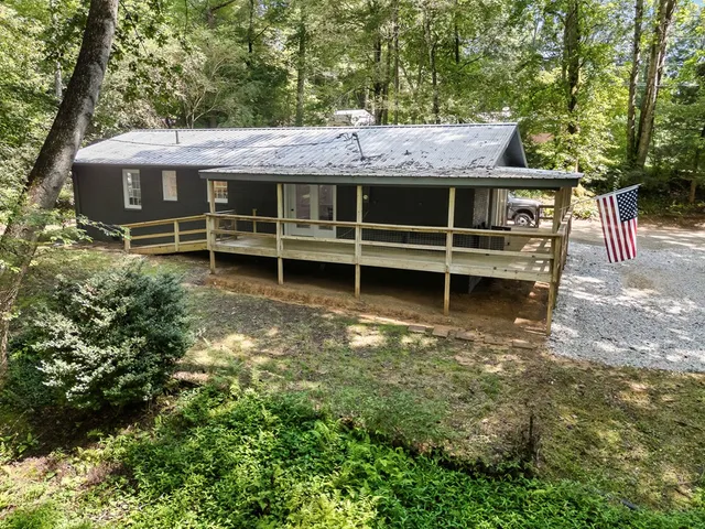 a backyard of a house with yard barbeque oven and outdoor seating