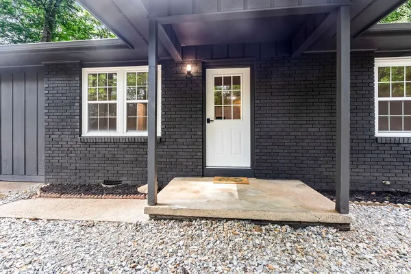 a view of a brick house with a yard