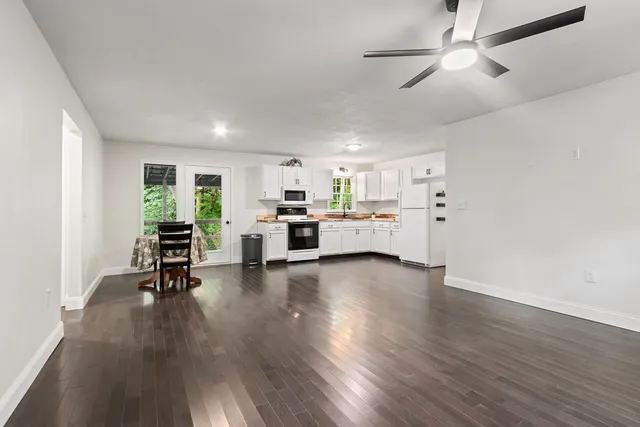 a living room with furniture and kitchen view