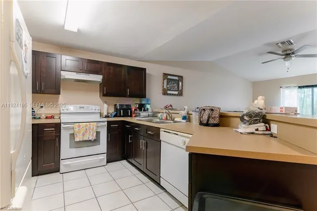 a kitchen with a sink cabinets and stainless steel appliances