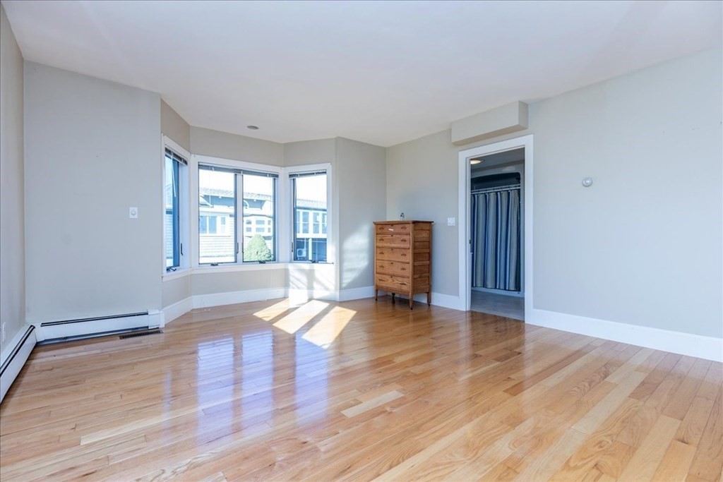 106 North Ridge Road Ipswich, MA 01938 - Photo 13 of 42 a view of an empty room with window and wooden floor