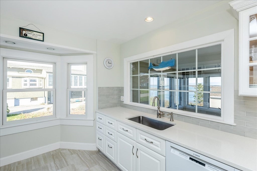 106 North Ridge Road Ipswich, MA 01938 - Photo 5 of 42 a kitchen with granite countertop a sink and a window