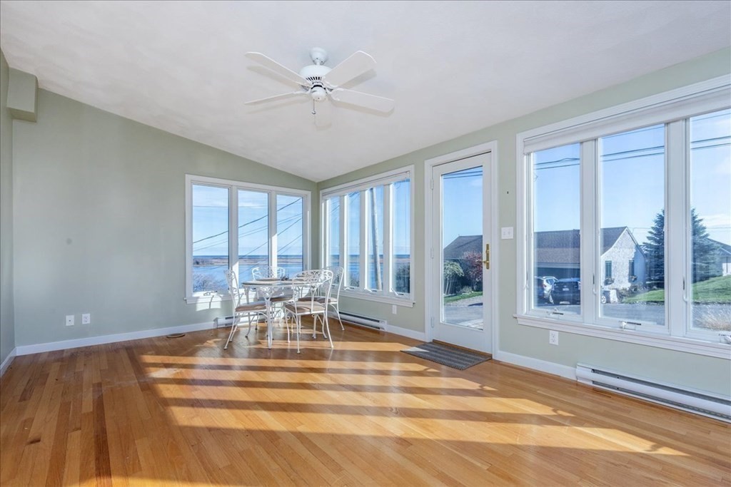 106 North Ridge Road Ipswich, MA 01938 - Photo 10 of 42 a dining room with wooden floor and a chandelier