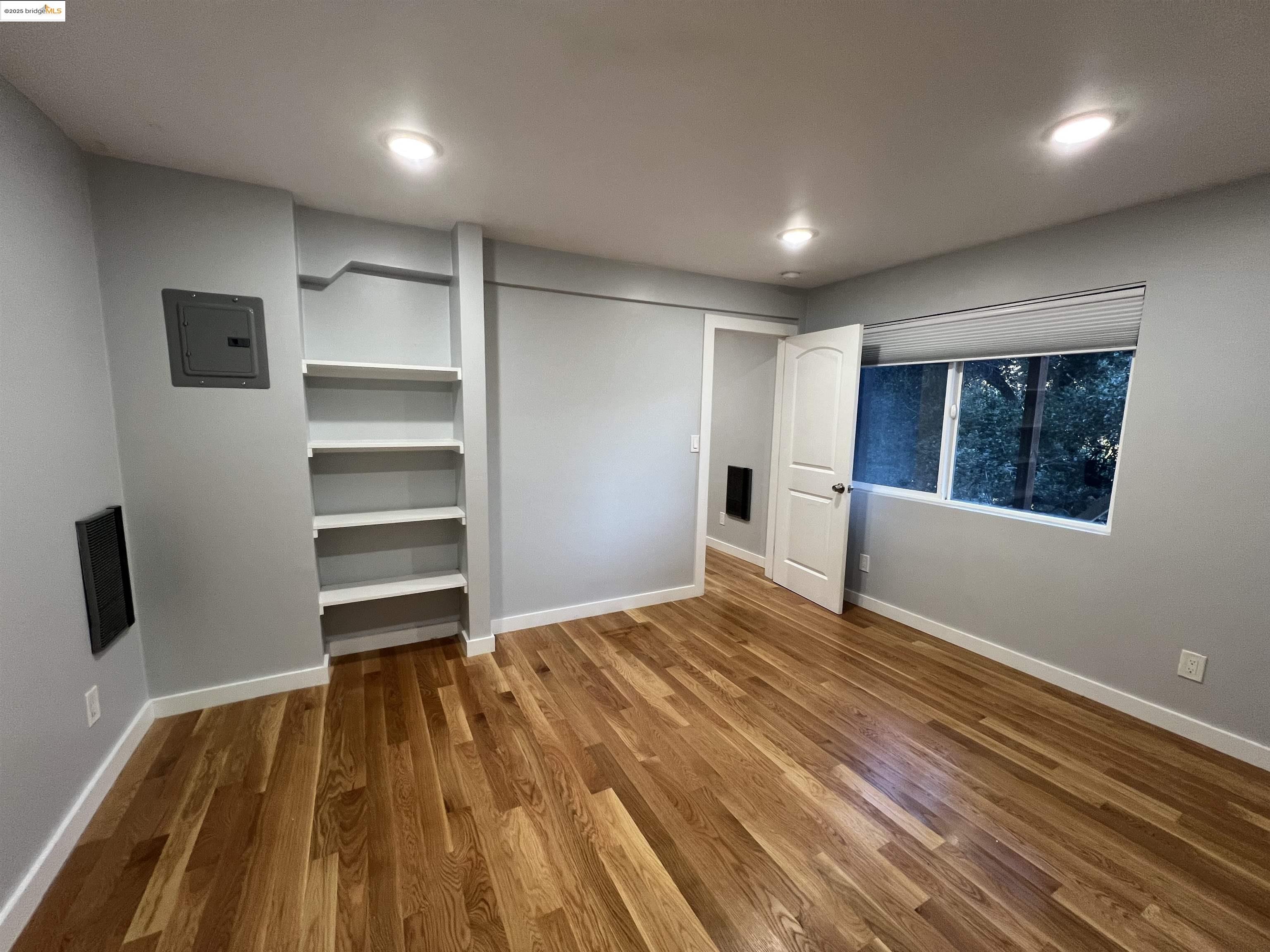 900 Everett Avenue, Unit A Oakland, CA 94602 - Photo 6 of 10 a view of empty room with wooden floor and fan