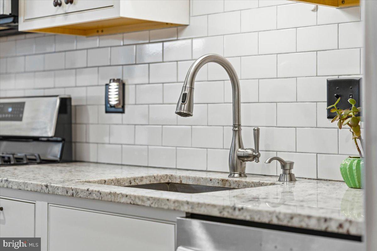 37 East 5th Street Frederick, MD 21701 - Photo 12 of 50 a bathroom with a granite countertop sink and a mirror