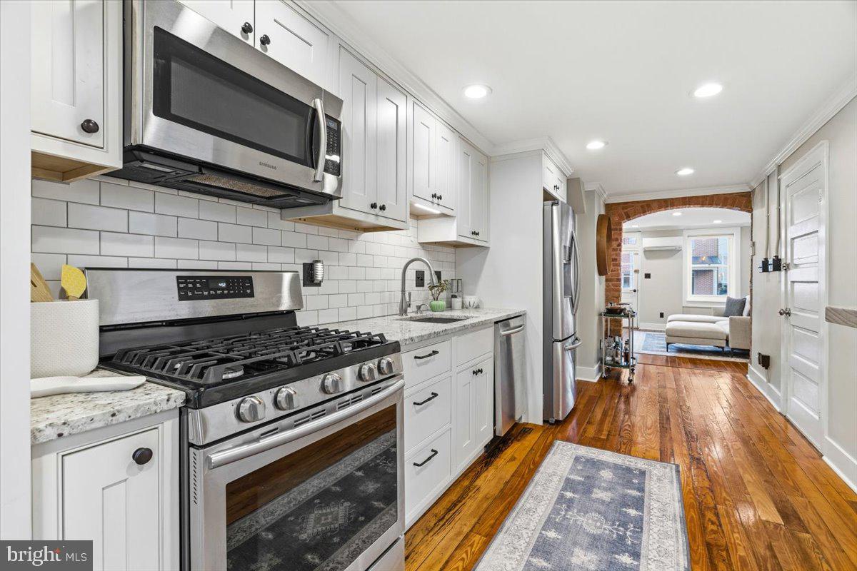 37 East 5th Street Frederick, MD 21701 - Photo 13 of 50 a kitchen with stainless steel appliances granite countertop a stove and a microwave