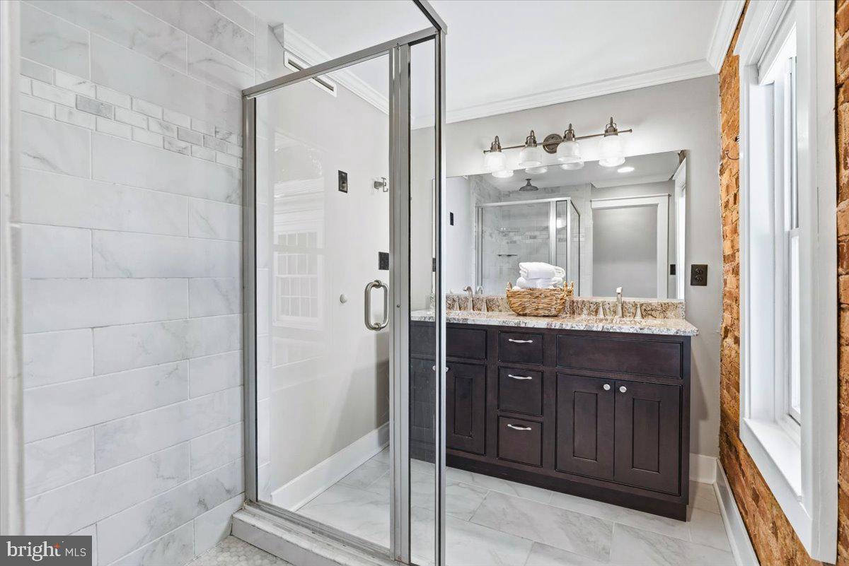 37 East 5th Street Frederick, MD 21701 - Photo 28 of 50 a bathroom with a granite countertop sink mirror and shower