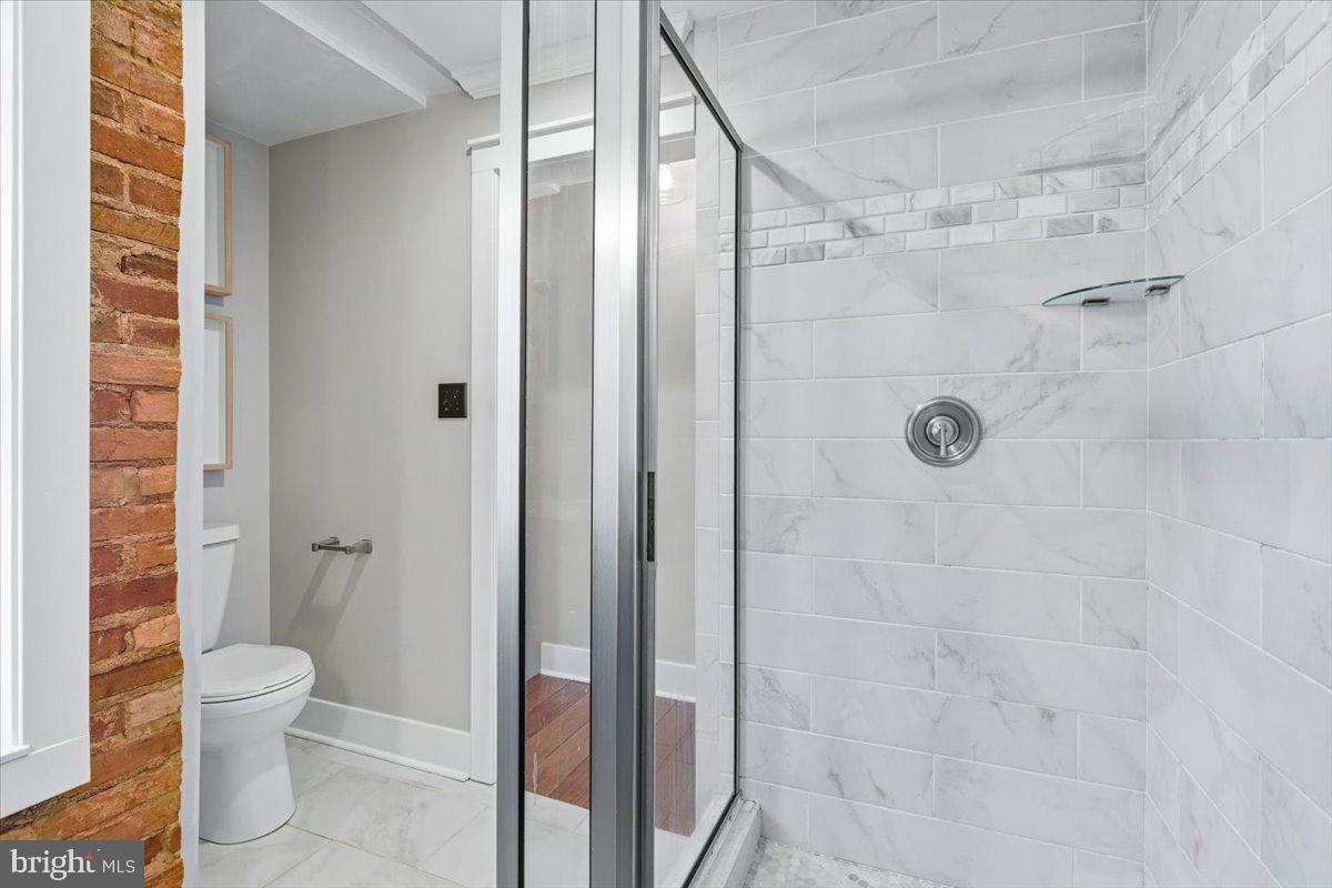 37 East 5th Street Frederick, MD 21701 - Photo 30 of 50 a bathroom with a shower and a toilet