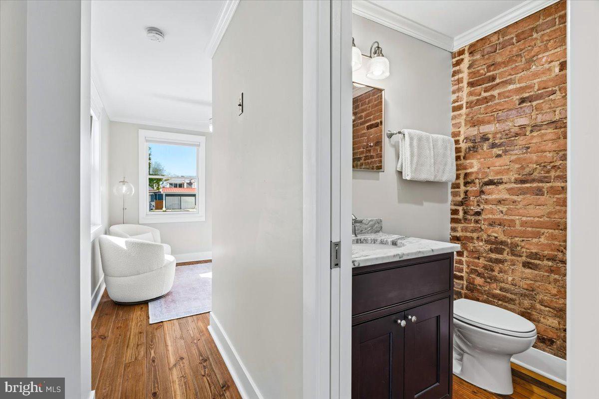 37 East 5th Street Frederick, MD 21701 - Photo 32 of 50 a bathroom with a toilet sink and mirror