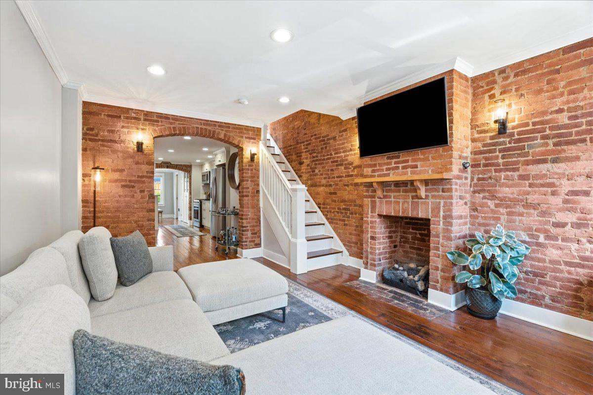 37 East 5th Street Frederick, MD 21701 - Photo 4 of 50 a living room with furniture a flat screen tv and a fireplace