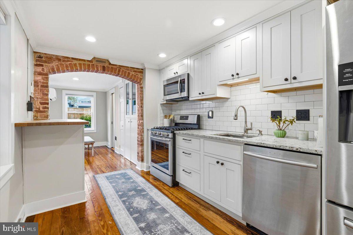 37 East 5th Street Frederick, MD 21701 - Photo 7 of 50 a kitchen with stainless steel appliances granite countertop a refrigerator and stove