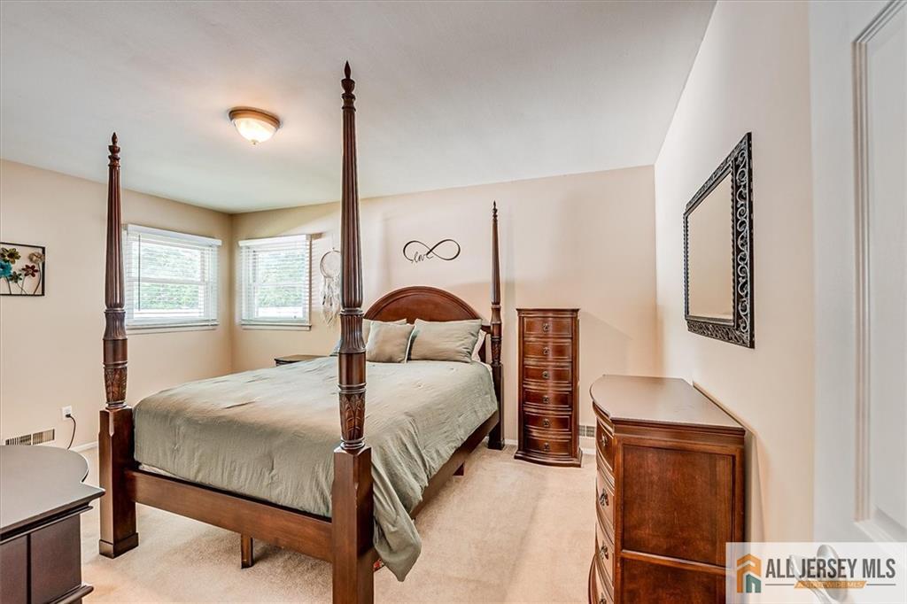 20 Melville Road Edison, NJ 08817 - Photo 13 of 31 a bedroom with a bed lamp and a window